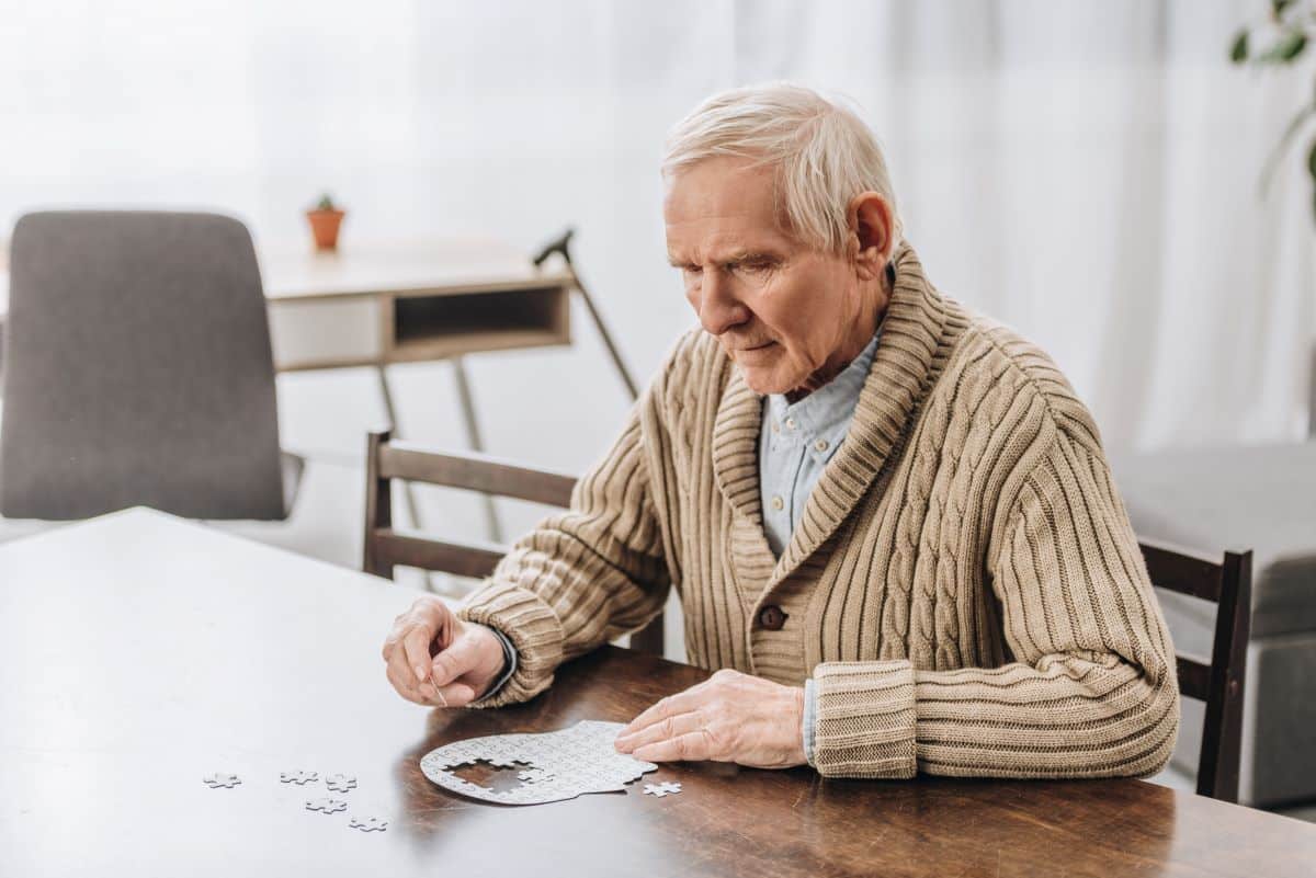 Pensioner putting together puzzle links to solving the annuity puzzle