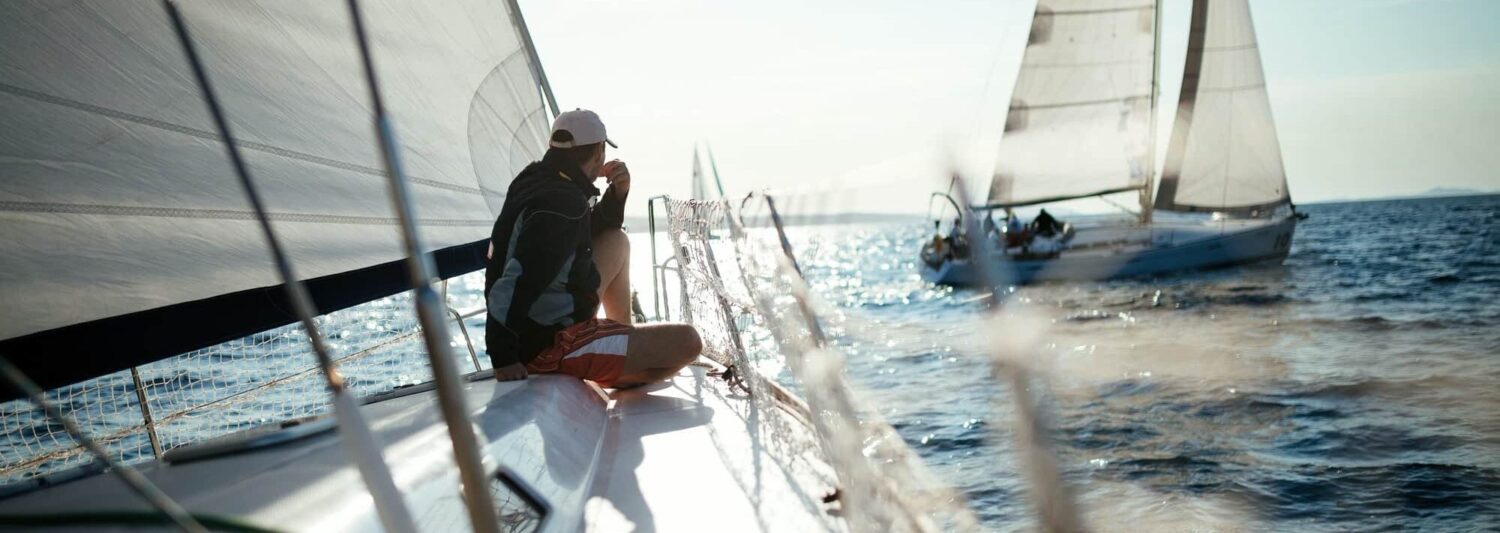 Gainbridge Annuity Review and Profile Featured Image - Picture of Young handsome man relaxing on his sailboat