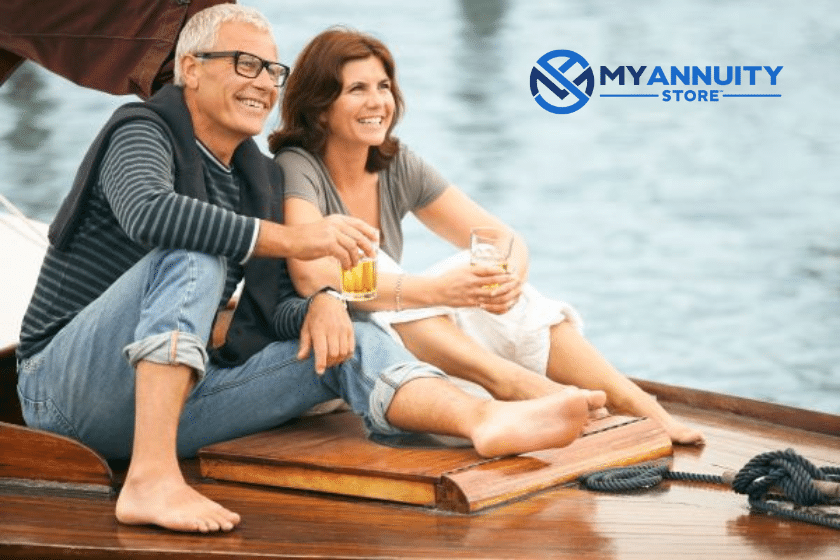 Valic variable annuity life insurance company - retired couple sitting on end of a wooden sailboat.
